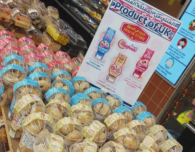 Simply Doughnuts tubs stacked on a retail display beneath a Product of UK sign