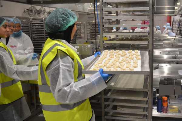 Students experience working on the doughnut production line.
